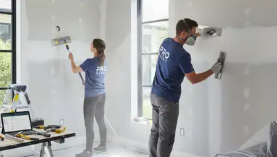 Technician repairing drywall cracks in Saint Charles, MO home for expert wall restoration service