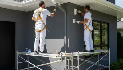 Painter finishing exterior trim and fascia on home in Saint Charles, MO for expert, durable results